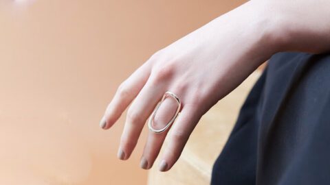 A person wearing a ring on their finger